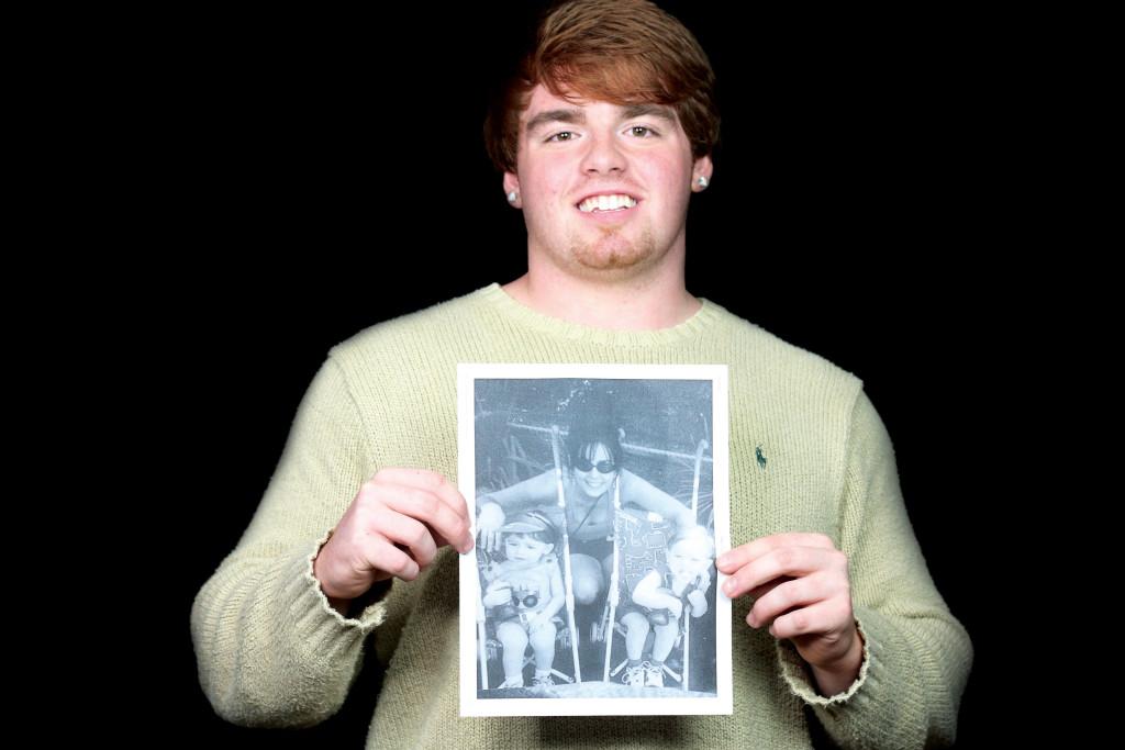 Ben Howell shows off an old picture depicting his twin brother and mother. Photo By Jordyn Stumpf 