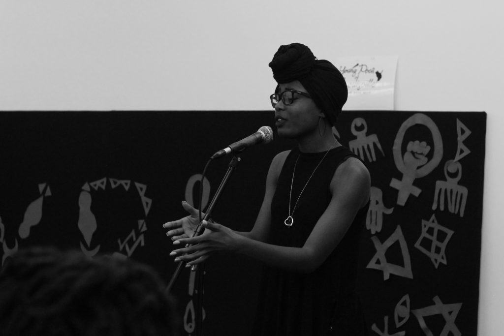 SPEAK YOUR MIND: Jasmine Frederick (16, New Albany High School) performs her poem “Long Live the Queens” about beauty standards at the Floetic Friday Youth Poetry slam, held at the Speed Art Museum on Nov. 18. “I typically write about… things that I want to see in the future,” she said. // photo by SARAH SCHMIDT
