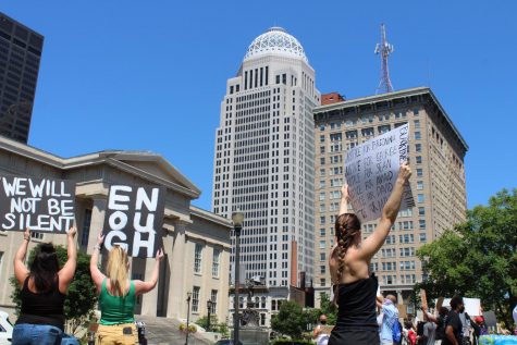 The Mercer Tower — one of Louisvilles most recognizable buildings on its skyline — sits in the background as demonstrators hold up signs and chant to protest police brutality on June 2, 2020.