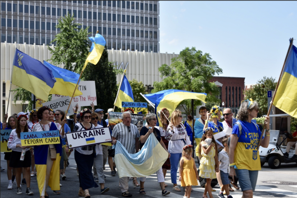 During the Parade of Cultures commencing WorldFest, Ukrainian representatives of all ages march while waving their flags and holding up signs, Sep. 2, 2023. Photo by Sophy Zhao