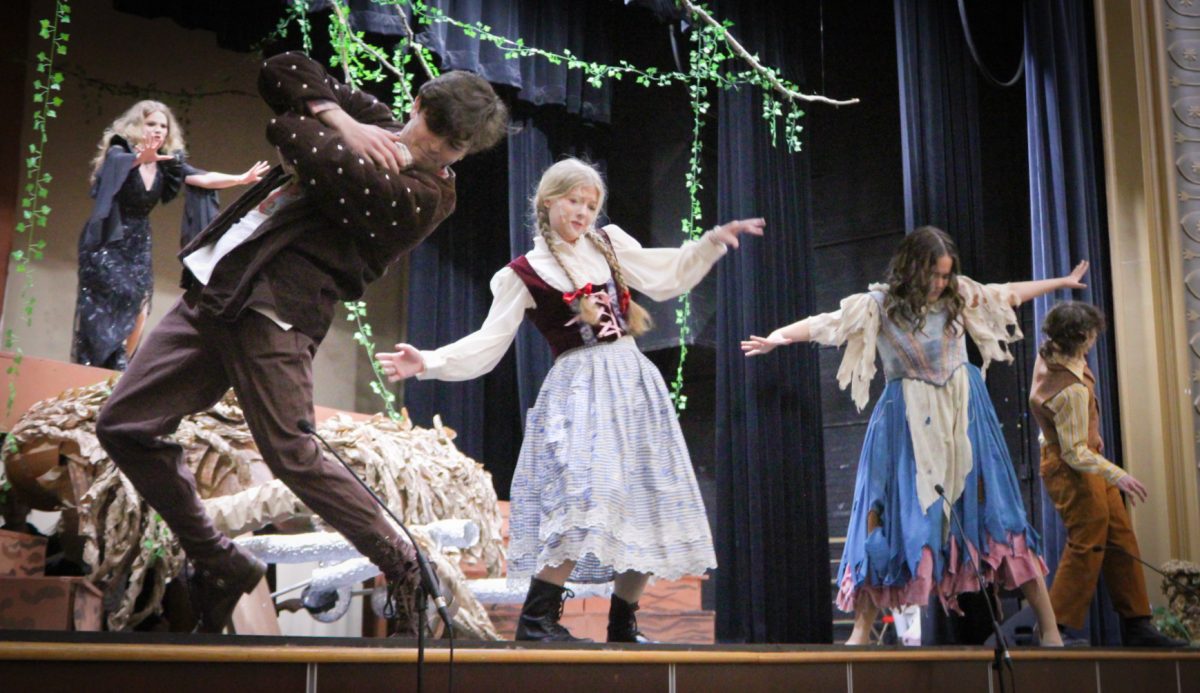 Setting the Scene – Cast members of Sacred Heart Academy’s “Into the Woods” rehearse diligently for the show before its opening. Onstage, they tremble from the wrath of the Wicked Witch during the song “Last Midnight” on Feb. 24.